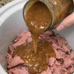Pour a jar of creamy gravy over sliced deli roast beef in the slow cooker with 2 other ingredients