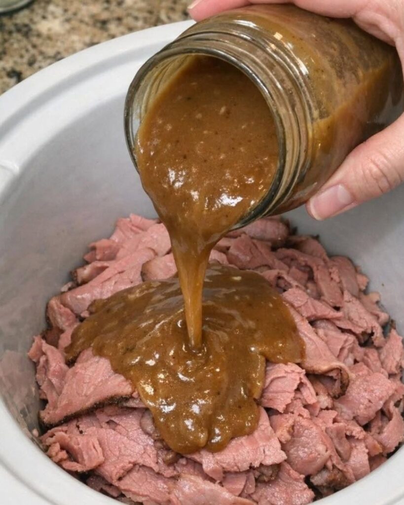 Pour a jar of creamy gravy over sliced deli roast beef in the slow cooker with 2 other ingredients