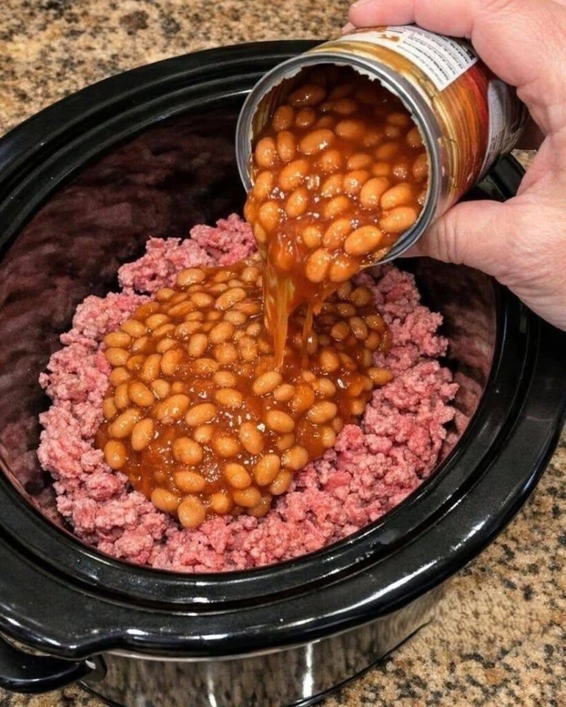 Pour canned baked beans over raw ground beef, together with 3 ingredients