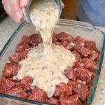 Pour cream of mushroom soup over raw beef stew meat, along with 2 other ingredients