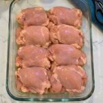 Dump raw boneless skinless chicken thighs in the 9×13 baking dish and 3 other ingredients