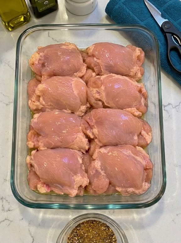 Dump raw boneless skinless chicken thighs in the 9×13 baking dish and 3 other ingredients
